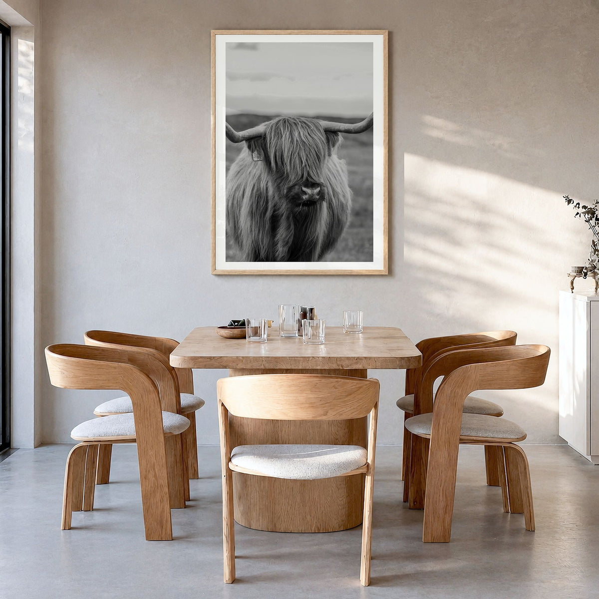Highland Cow Photo No 2 Poster in a natural wood frame, hanging in a dining room, white border