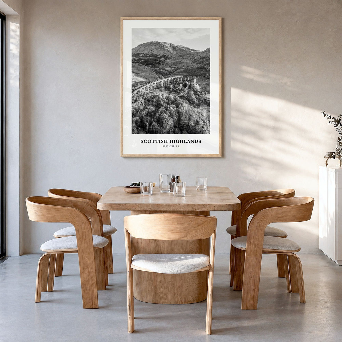 Scottish Highlands Classic Poster in a natural wood frame, hanging in a dining room
