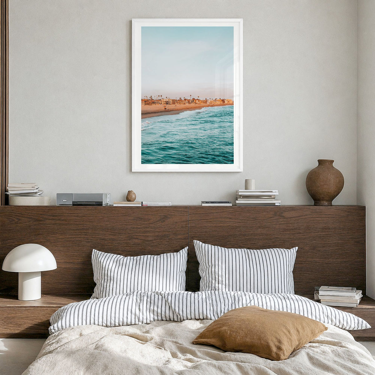 Seal Beach Photo Poster in a white wood frame, hanging in a bedroom, white border