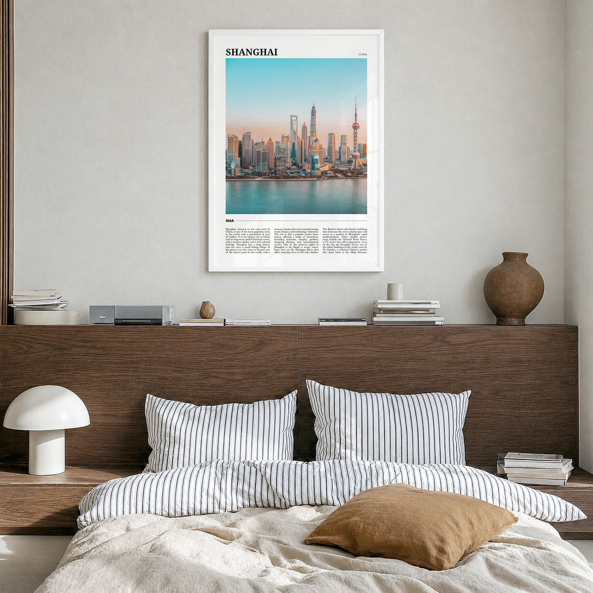Shanghai Travel Poster in a white wood frame, hanging in a bedroom
