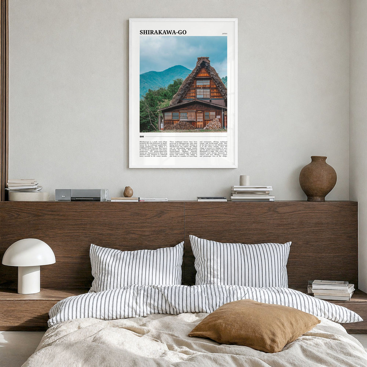 Shirakawa-go Travel Poster in a white wood frame, hanging in a bedroom