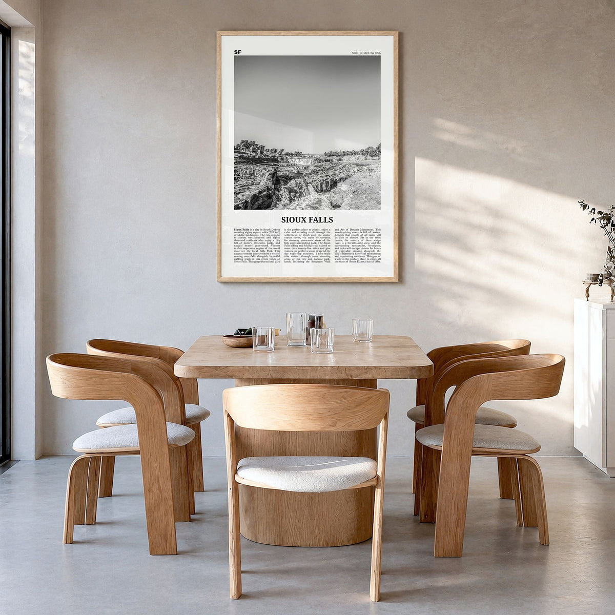 Sioux Falls Newspaper Poster in a natural wood frame, hanging in a dining room