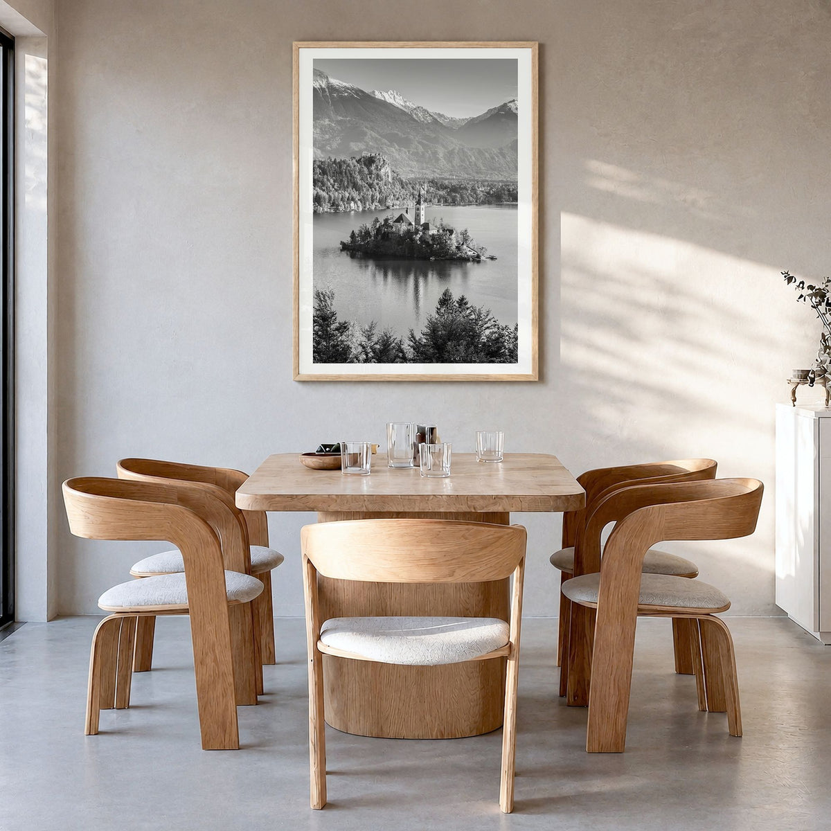 Slovenia Photo Poster in a natural wood frame, hanging in a dining room, white border
