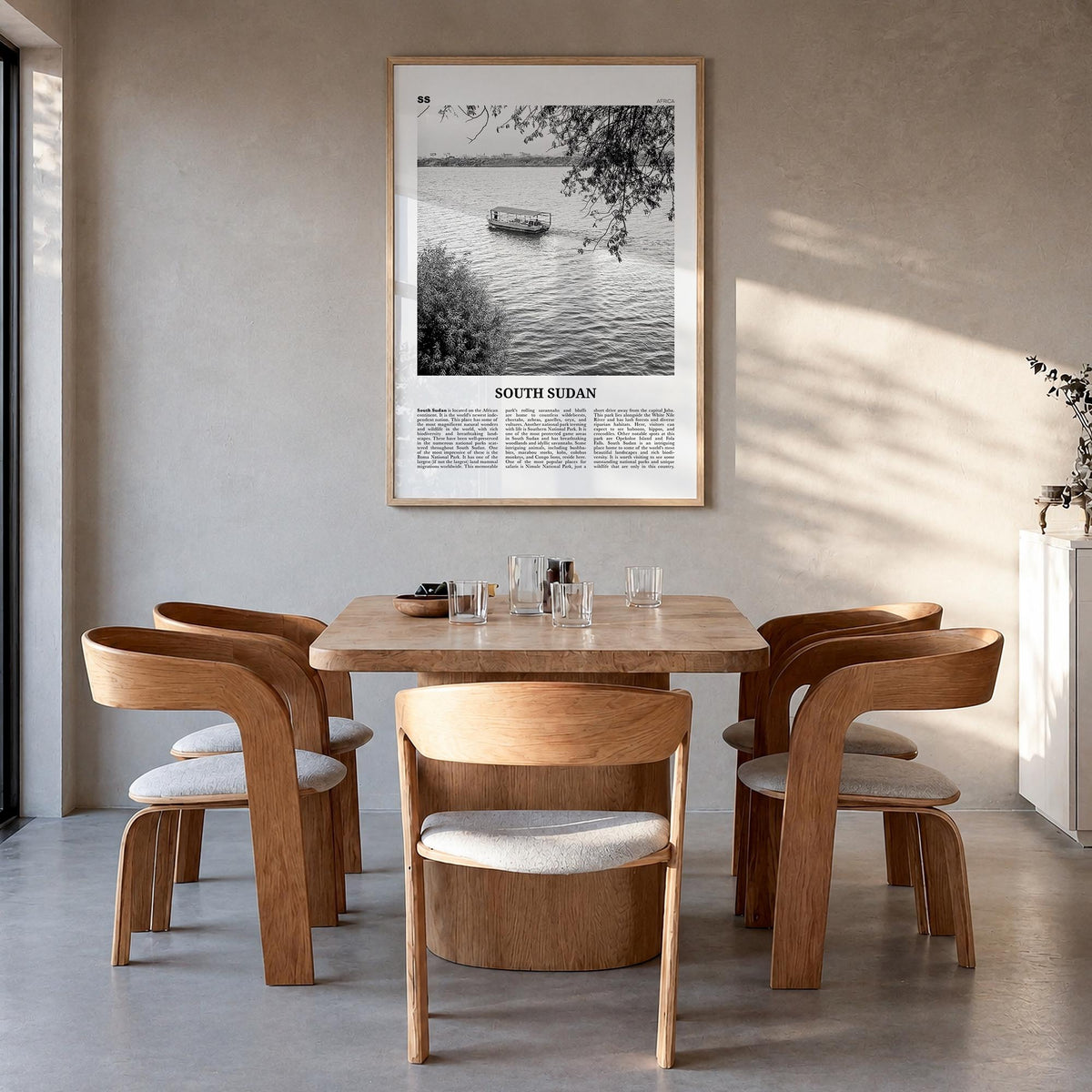 South Sudan black & white newspaper poster of Africa – vertical wall art in natural wood frame, hanging on wall