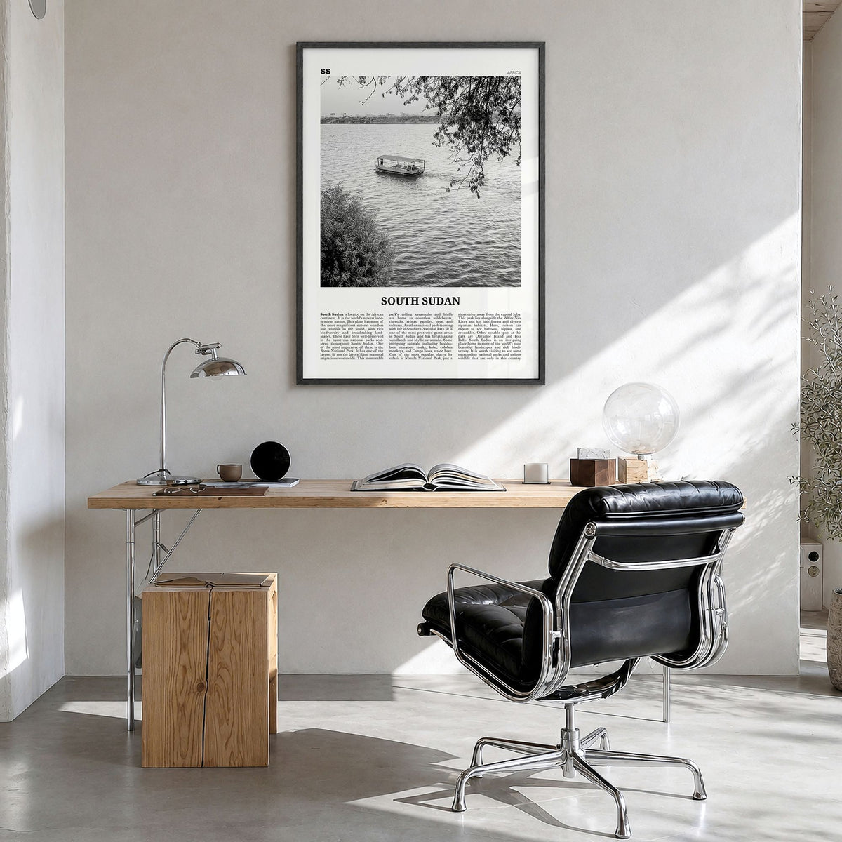 South Sudan Newspaper Poster in a black wood frame, hanging in a bright home office