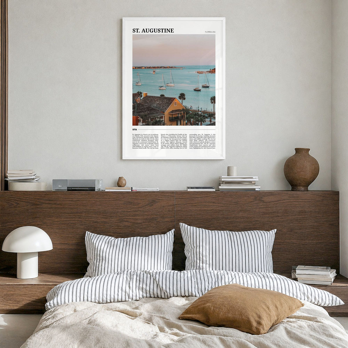 St. Augustine Travel Poster in a white wood frame, hanging in a bedroom