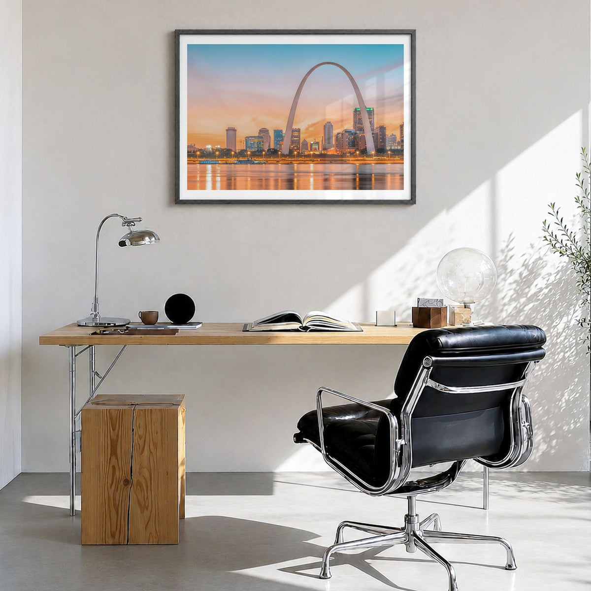 St. Louis Photo Poster in a black wood frame, hanging in a bright home office, white border