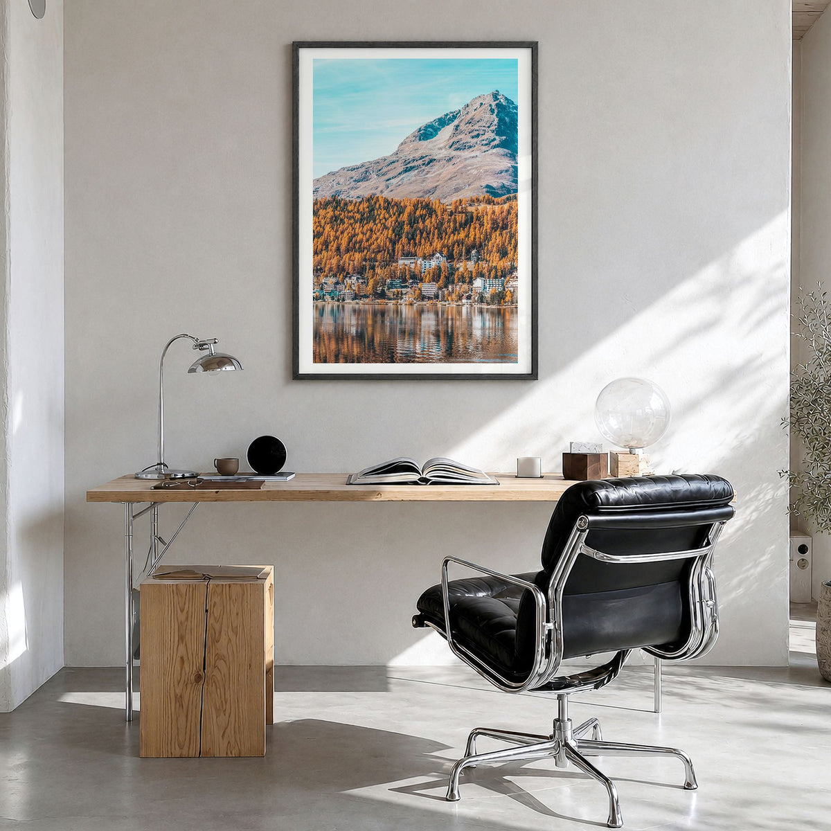 St. Moritz Photo Poster in a black wood frame, hanging in a bright home office, white border