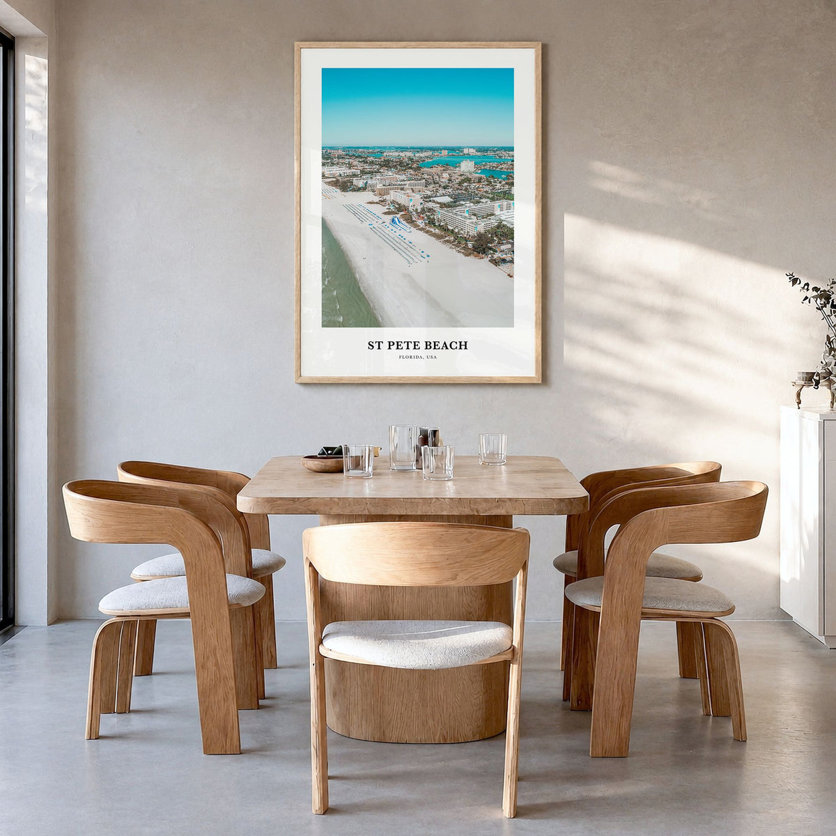 St. Pete Beach Classic Poster in a natural wood frame, hanging in a dining room