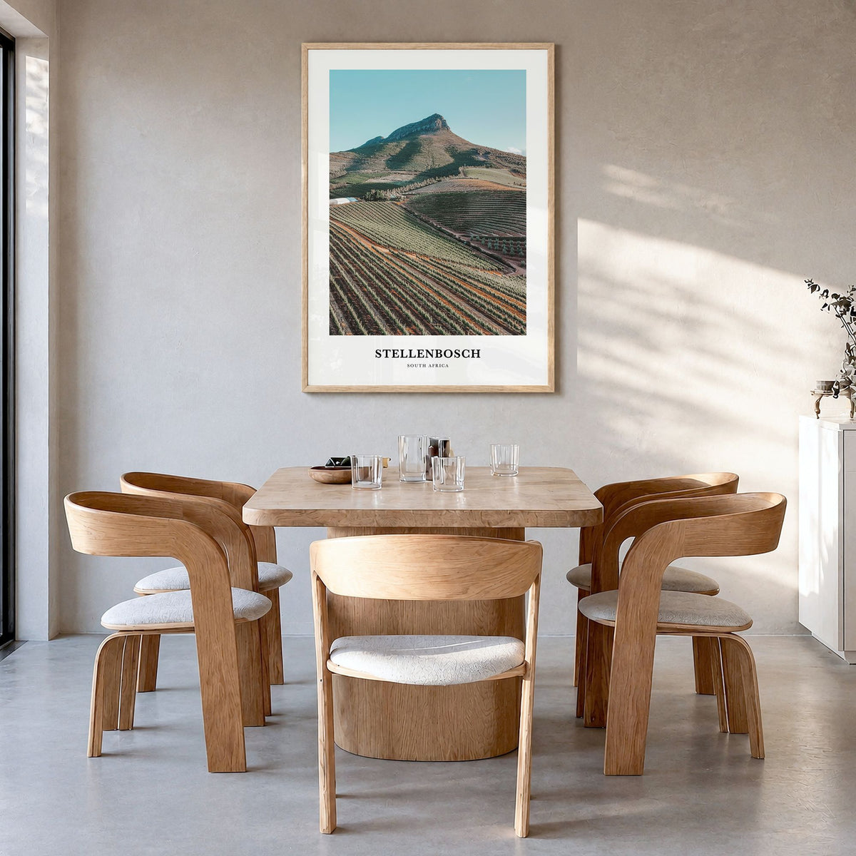 Stellenbosch Classic Poster in a natural wood frame, hanging in a dining room