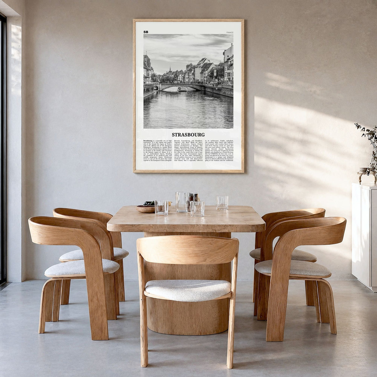Strasbourg Newspaper Poster in a natural wood frame, hanging in a dining room