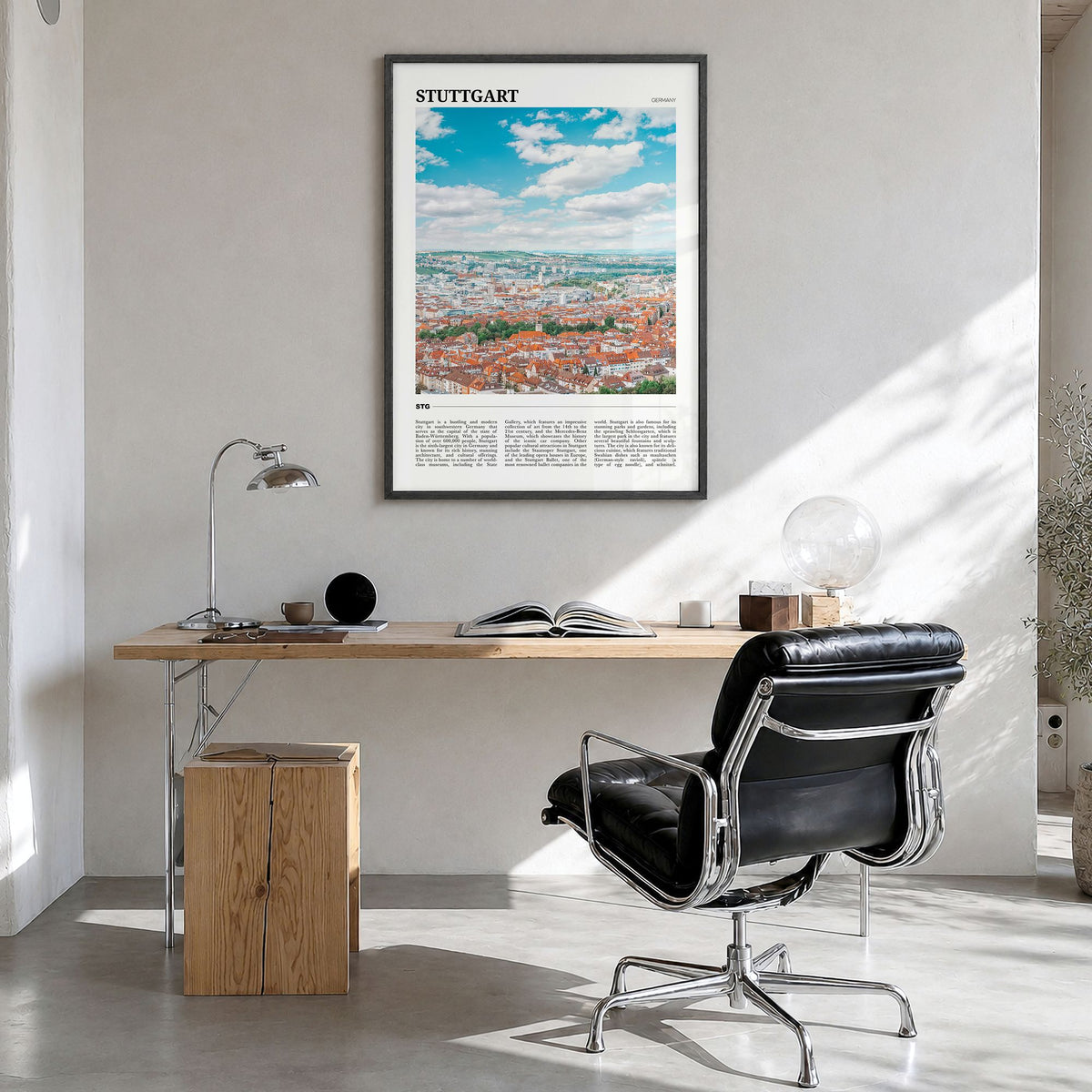 Stuttgart Travel Poster in a black wood frame, hanging in a bright home office