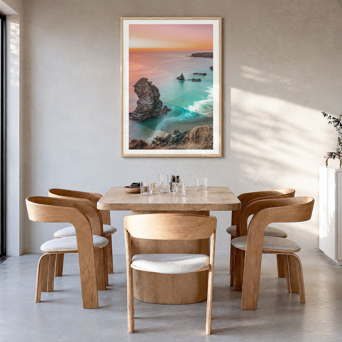 Sunset Cliffs Photo No 1 Poster in a natural wood frame, hanging in a dining room, white border