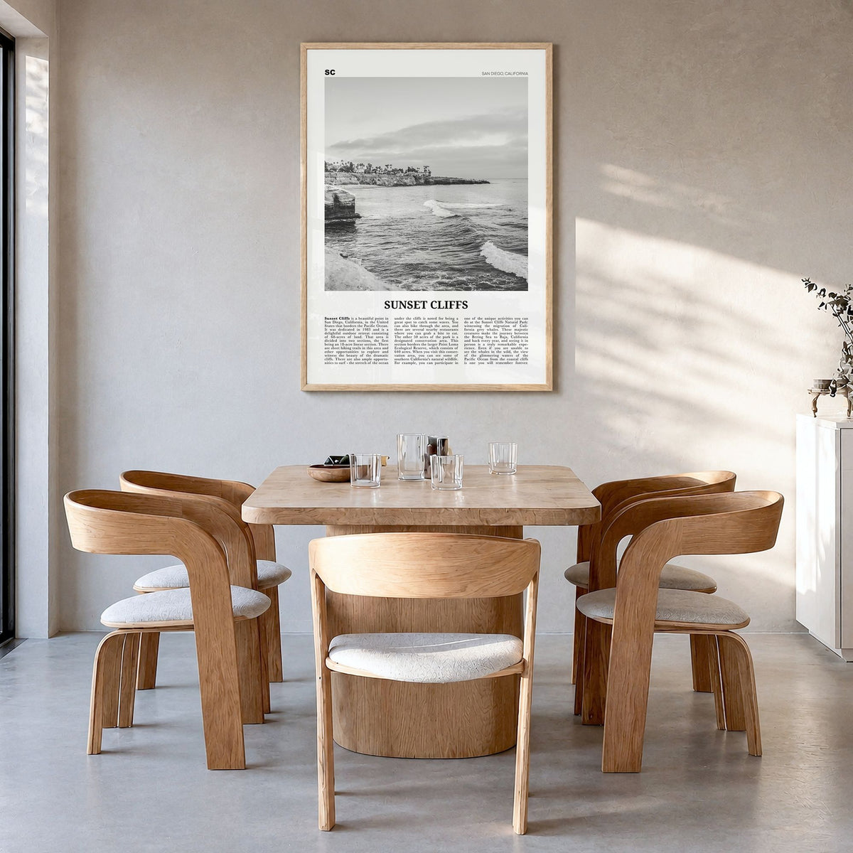 Sunset Cliffs Newspaper Poster in a natural wood frame, hanging in a dining room