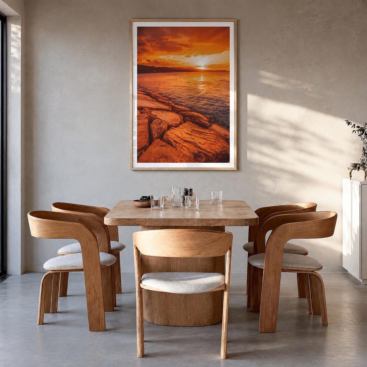 Sunset Coast colorful photo poster – vertical wall art in natural wood frame with white border, hanging on wall