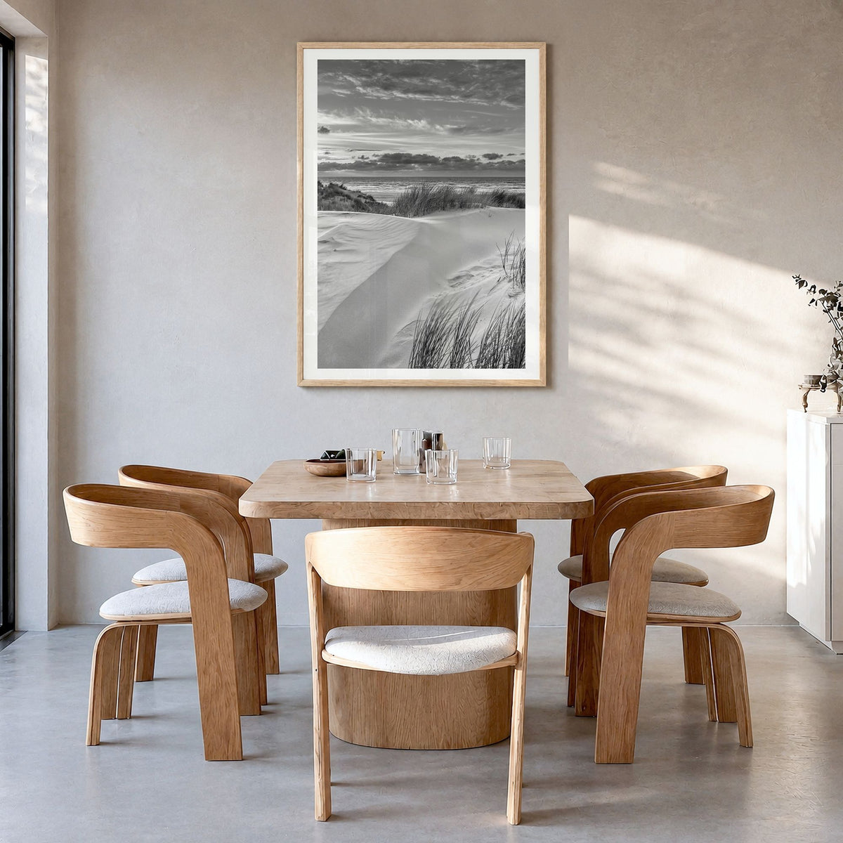 Sunset Coast Photo Poster in a natural wood frame, hanging in a dining room, white border