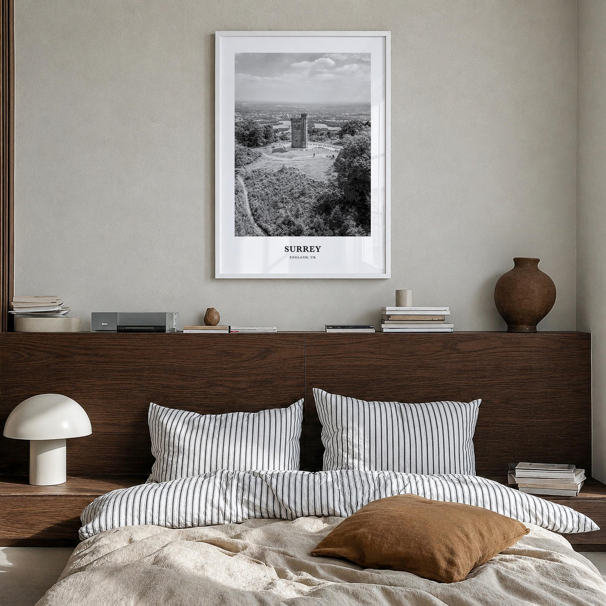 Surrey black & white classic poster of England, UK – vertical wall art in white wood frame, hanging on wall