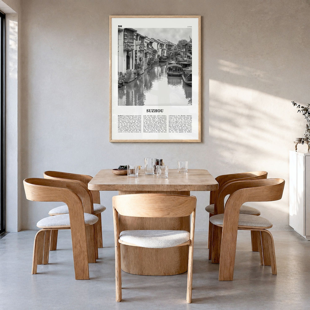 Suzhou Newspaper Poster in a natural wood frame, hanging in a dining room