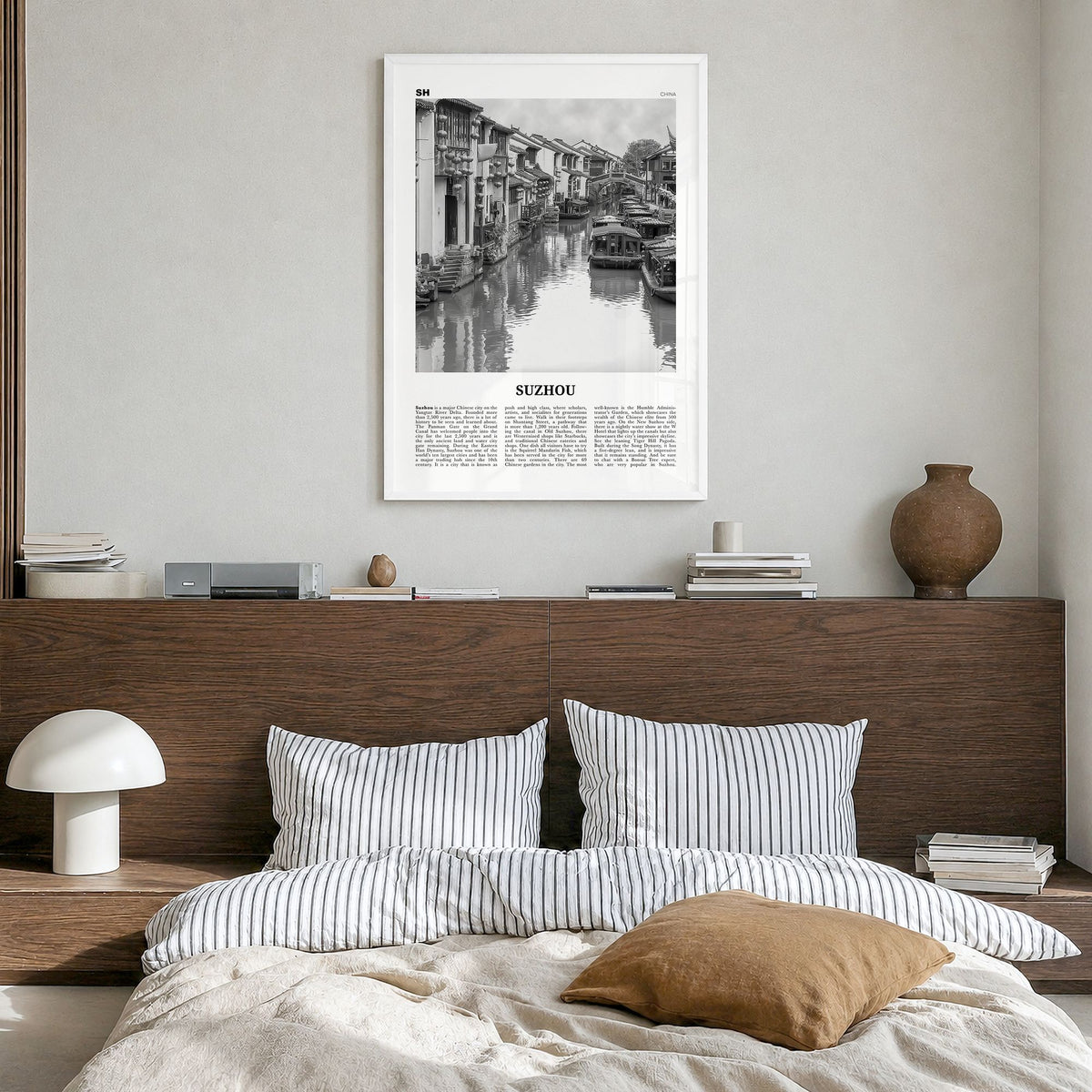 Suzhou Newspaper Poster in a white wood frame, hanging in a bedroom