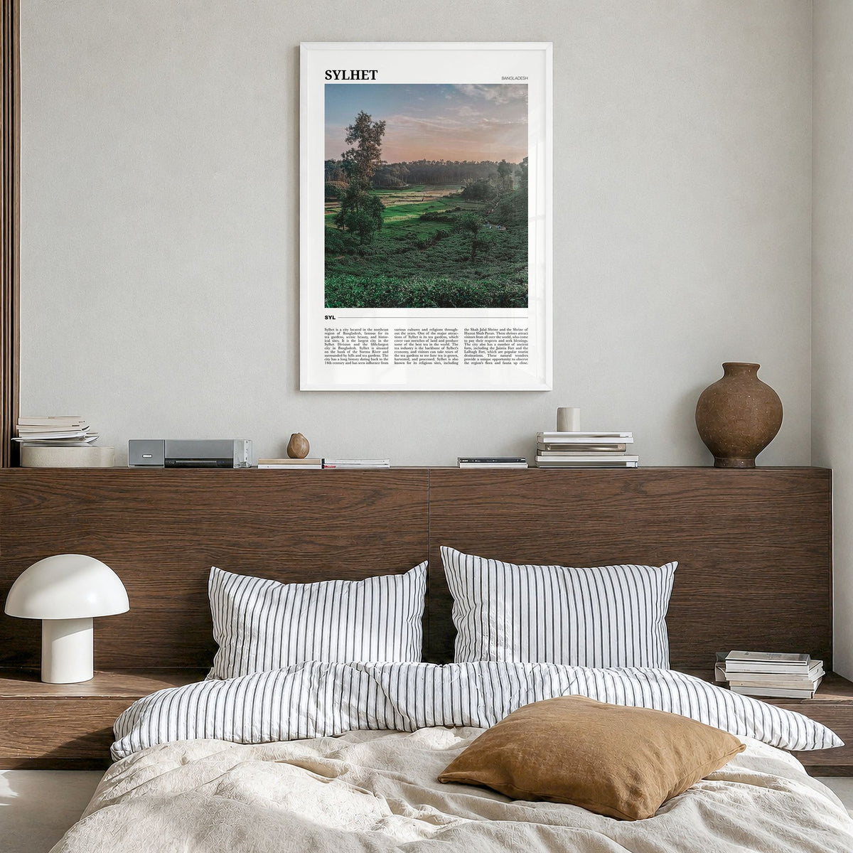Sylhet Travel Poster in a white wood frame, hanging in a bedroom