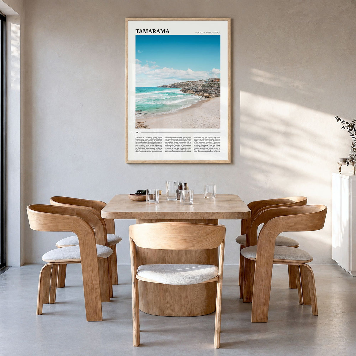 Tamarama Travel Poster in a natural wood frame, hanging in a dining room