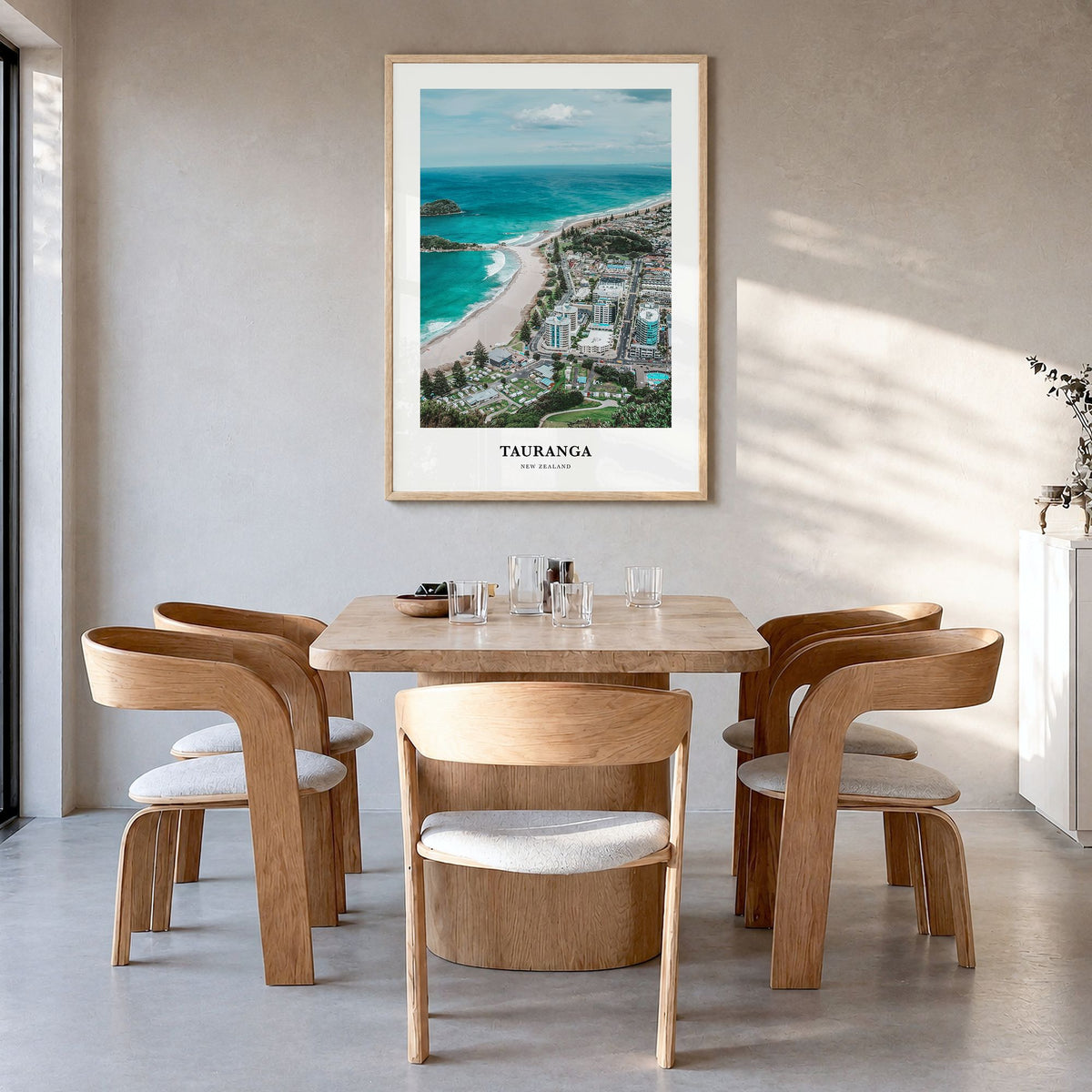 Tauranga Classic Poster in a natural wood frame, hanging in a dining room