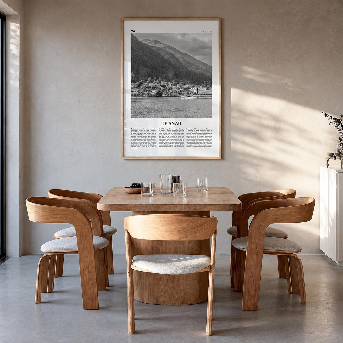 Te Anau black & white newspaper poster of New Zealand – vertical wall art in natural wood frame, hanging on wall