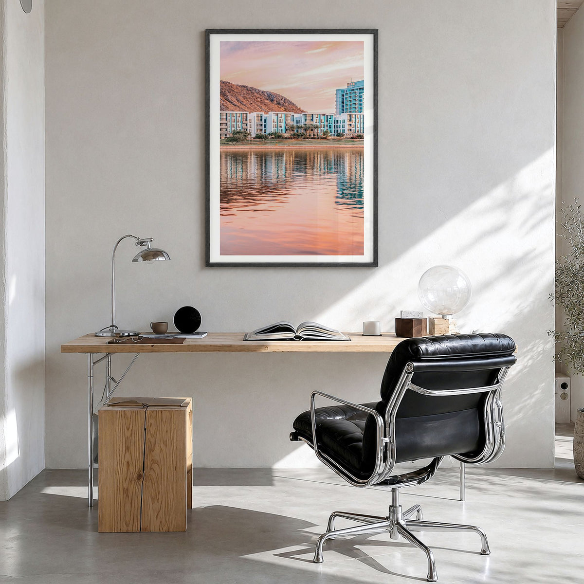 Tempe Photo Poster in a black wood frame, hanging in a bright home office, white border
