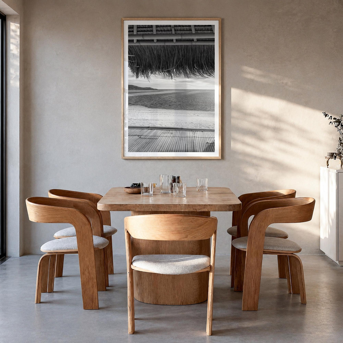 Thatched Hut no. 1 black & white photo poster – vertical wall art in natural wood frame with white border, hanging on wall