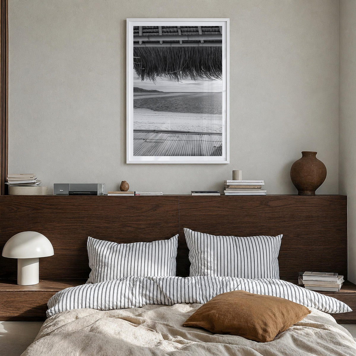 Thatched Hut no. 1 black & white photo poster – vertical wall art in white wood frame with white border, hanging on wall