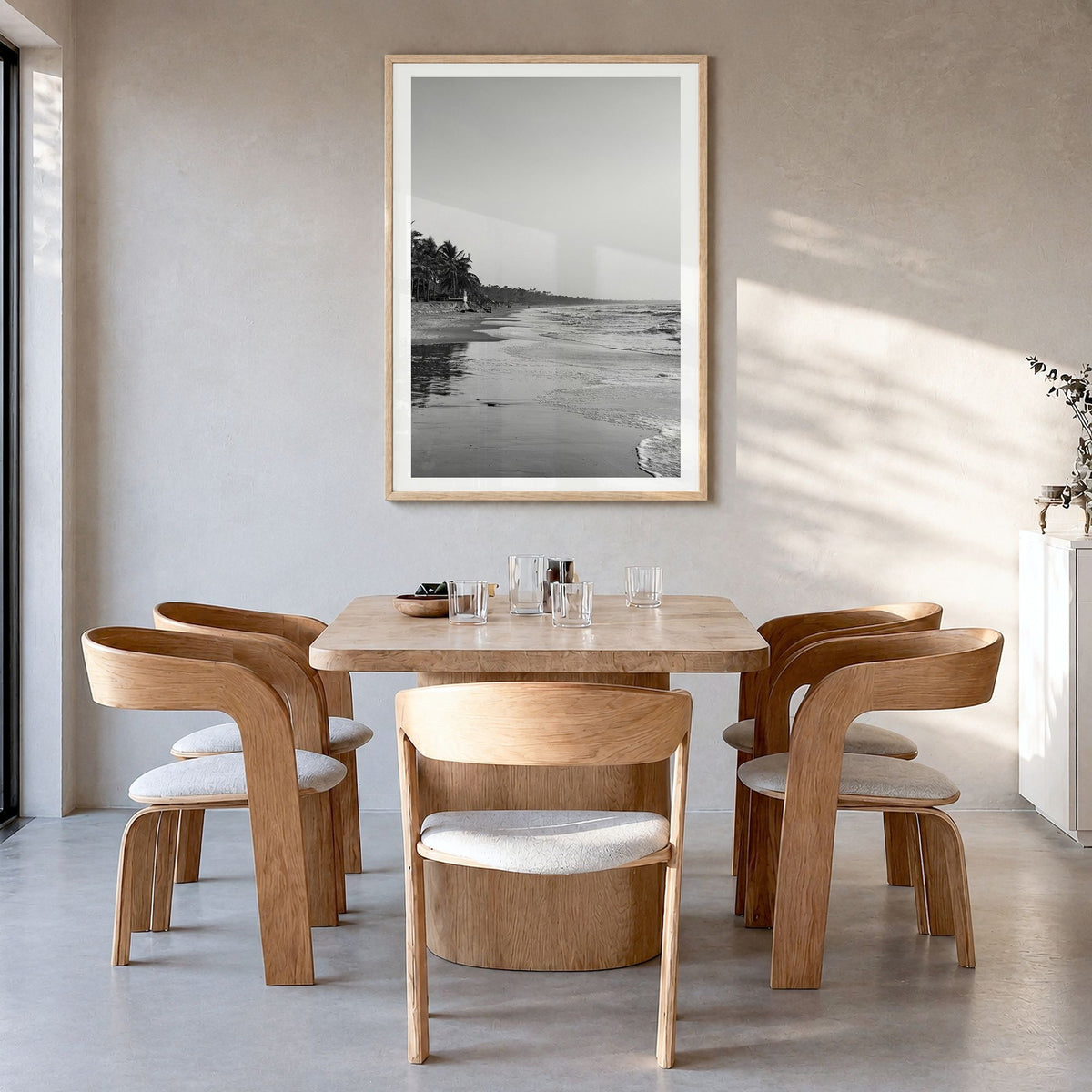 The Gambia Photo Poster in a natural wood frame, hanging in a dining room, white border