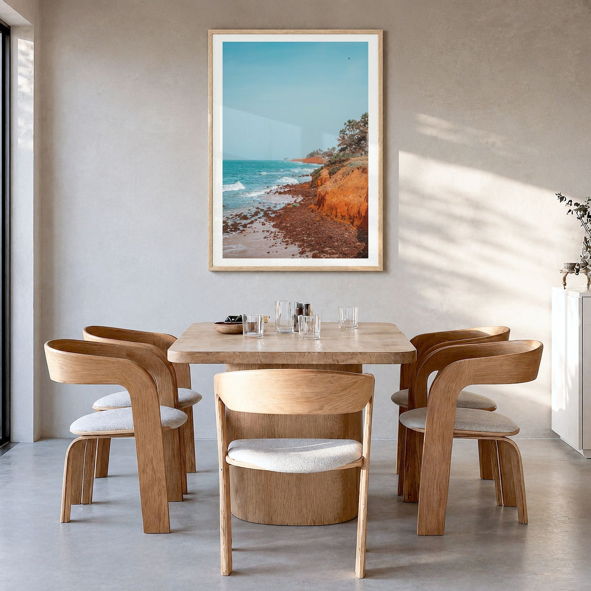 The Gambia Photo Poster in a natural wood frame, hanging in a dining room, white border