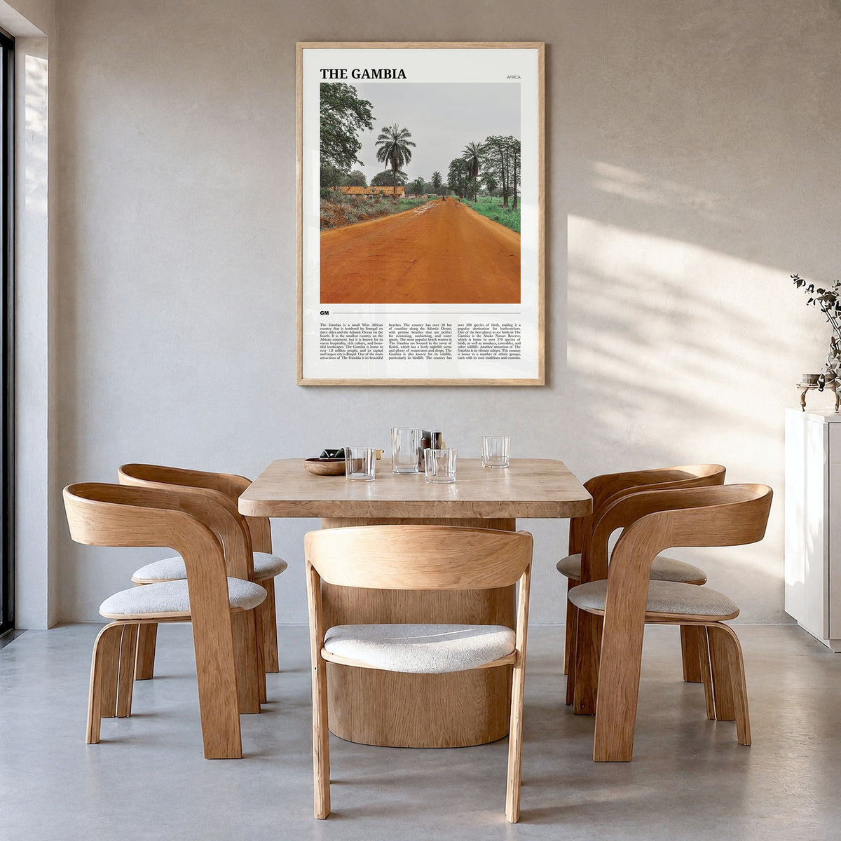The Gambia Travel Poster in a natural wood frame, hanging in a dining room
