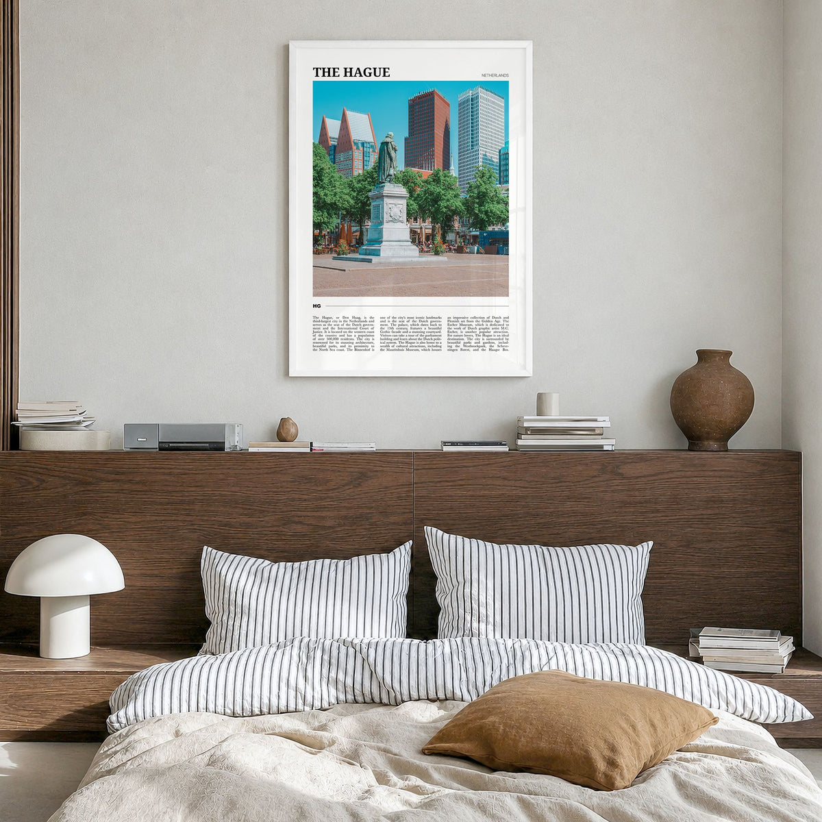 The Hague Travel Poster in a white wood frame, hanging in a bedroom