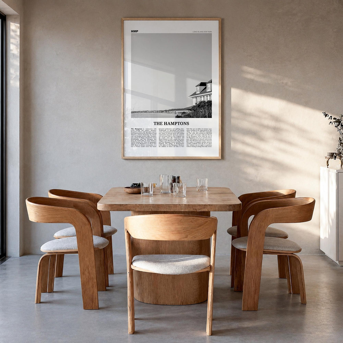 The Hamptons black & white newspaper poster of Long Island, New York – vertical wall art in natural wood frame, hanging on wa