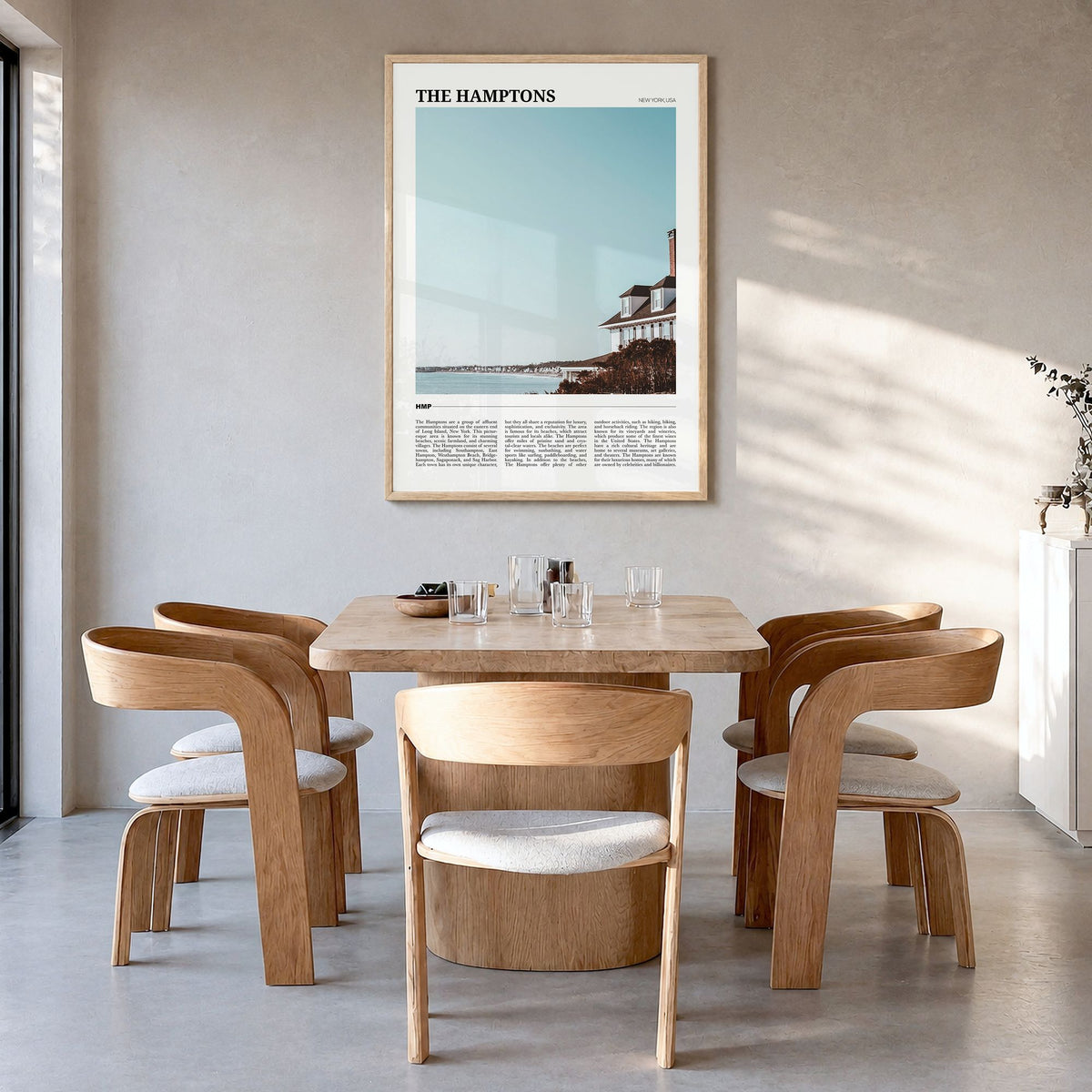 The Hamptons Travel Poster in a natural wood frame, hanging in a dining room