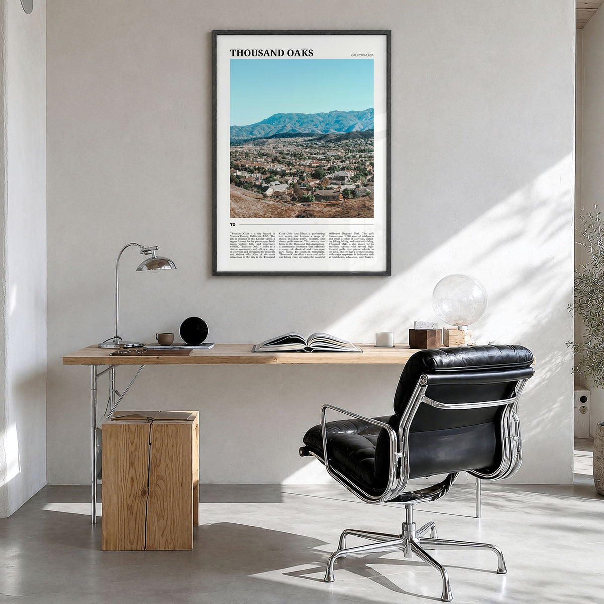 Thousand Oaks Travel Poster in a black wood frame, hanging in a bright home office