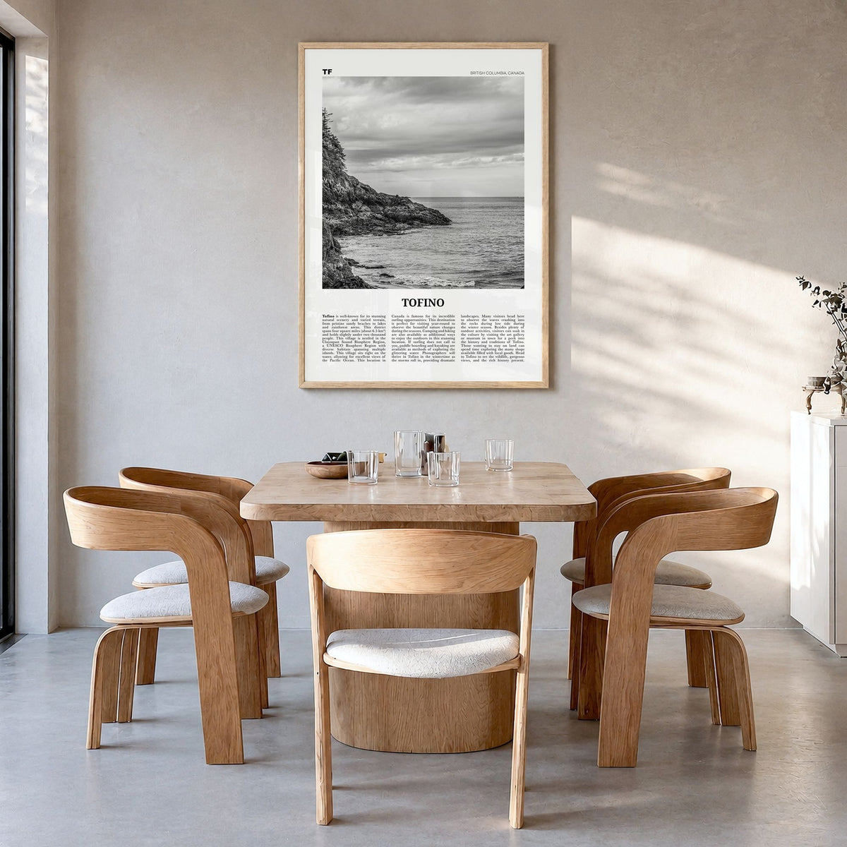 Tofino Newspaper Poster in a natural wood frame, hanging in a dining room