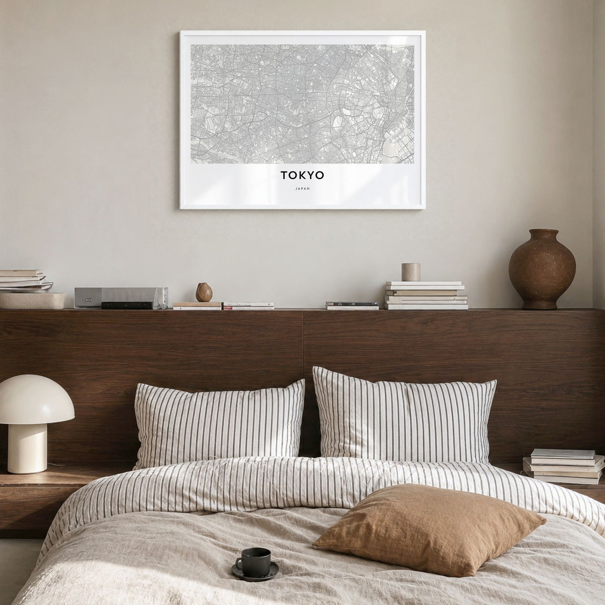 Tokyo Map Poster in a white wood frame, hanging in a bedroom