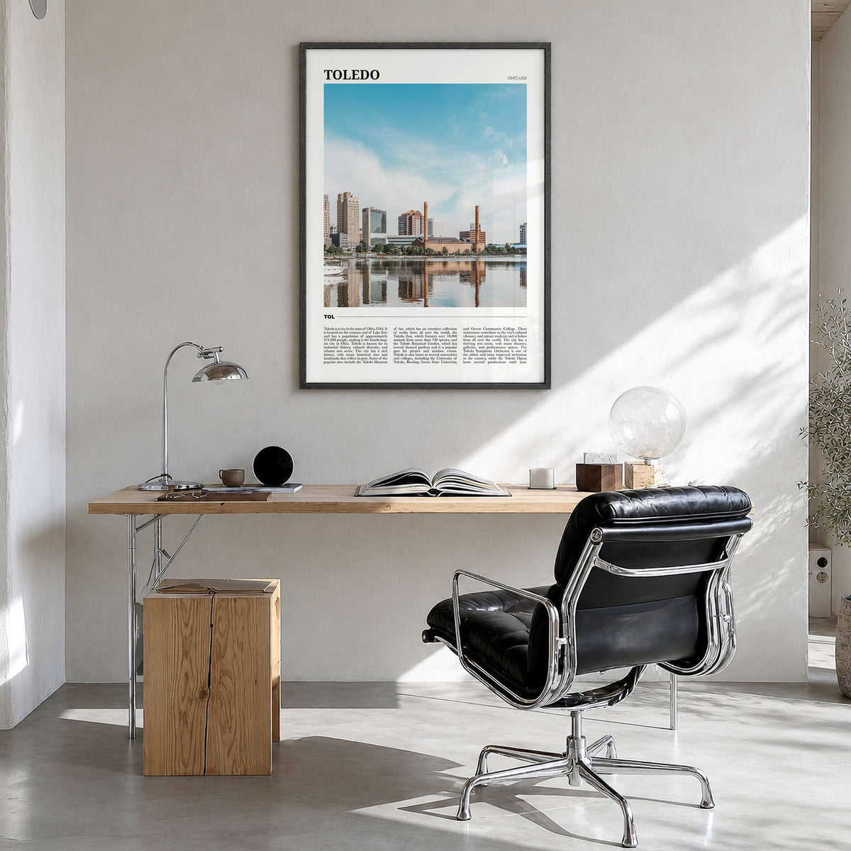 Toledo, Ohio Travel Poster in a black wood frame, hanging in a bright home office