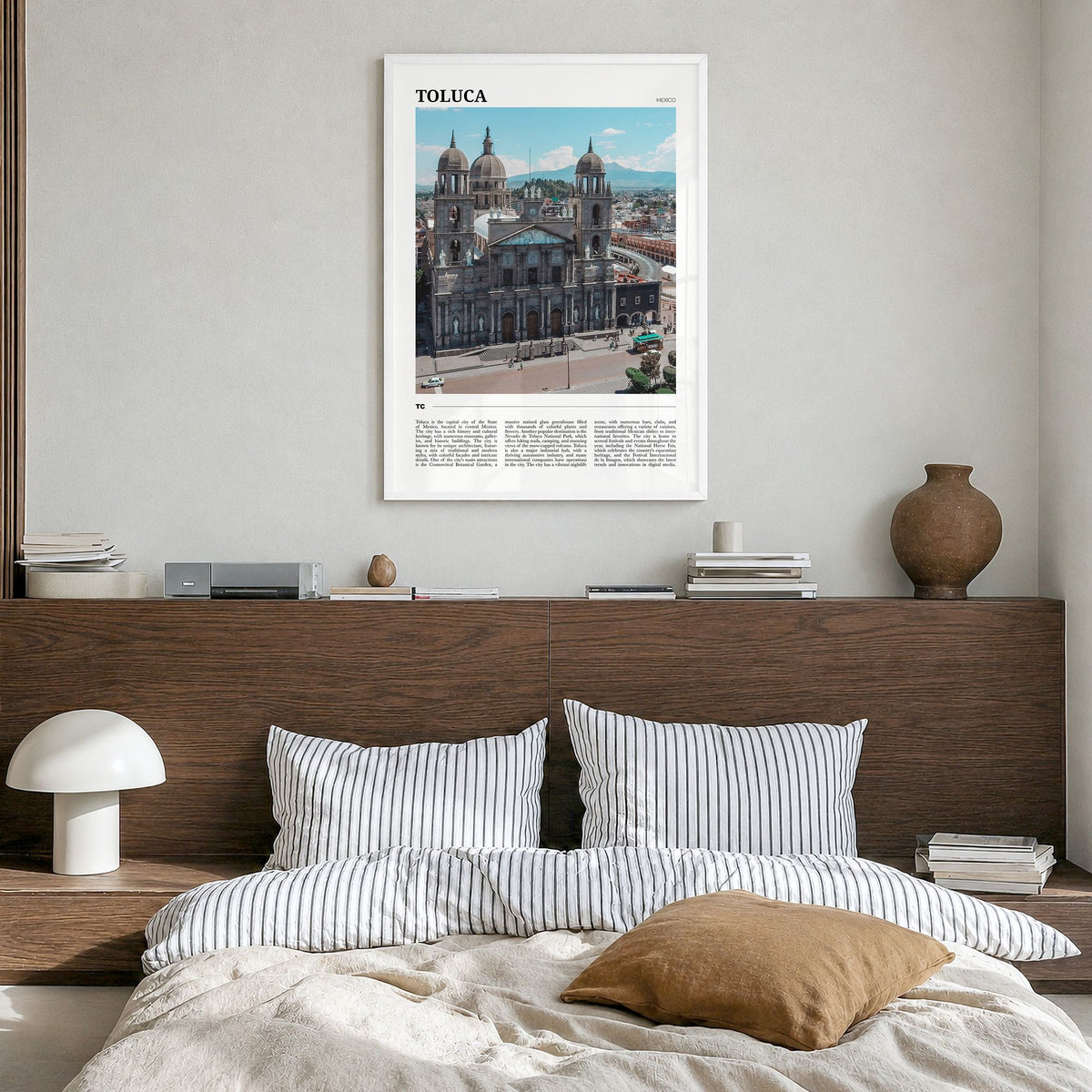 Toluca Travel Poster in a white wood frame, hanging in a bedroom