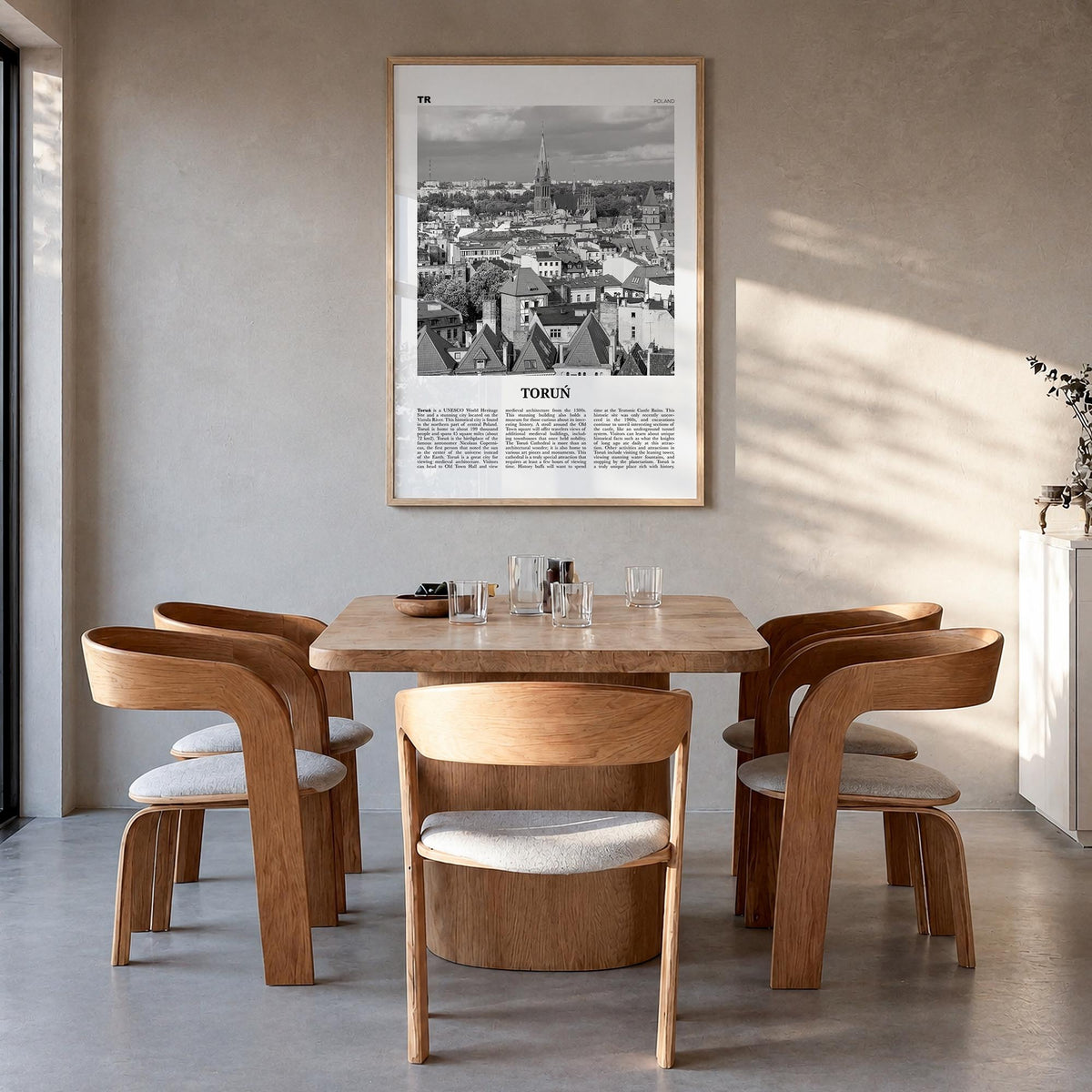 Toruń black & white newspaper poster of Poland – vertical wall art in natural wood frame, hanging on wall
