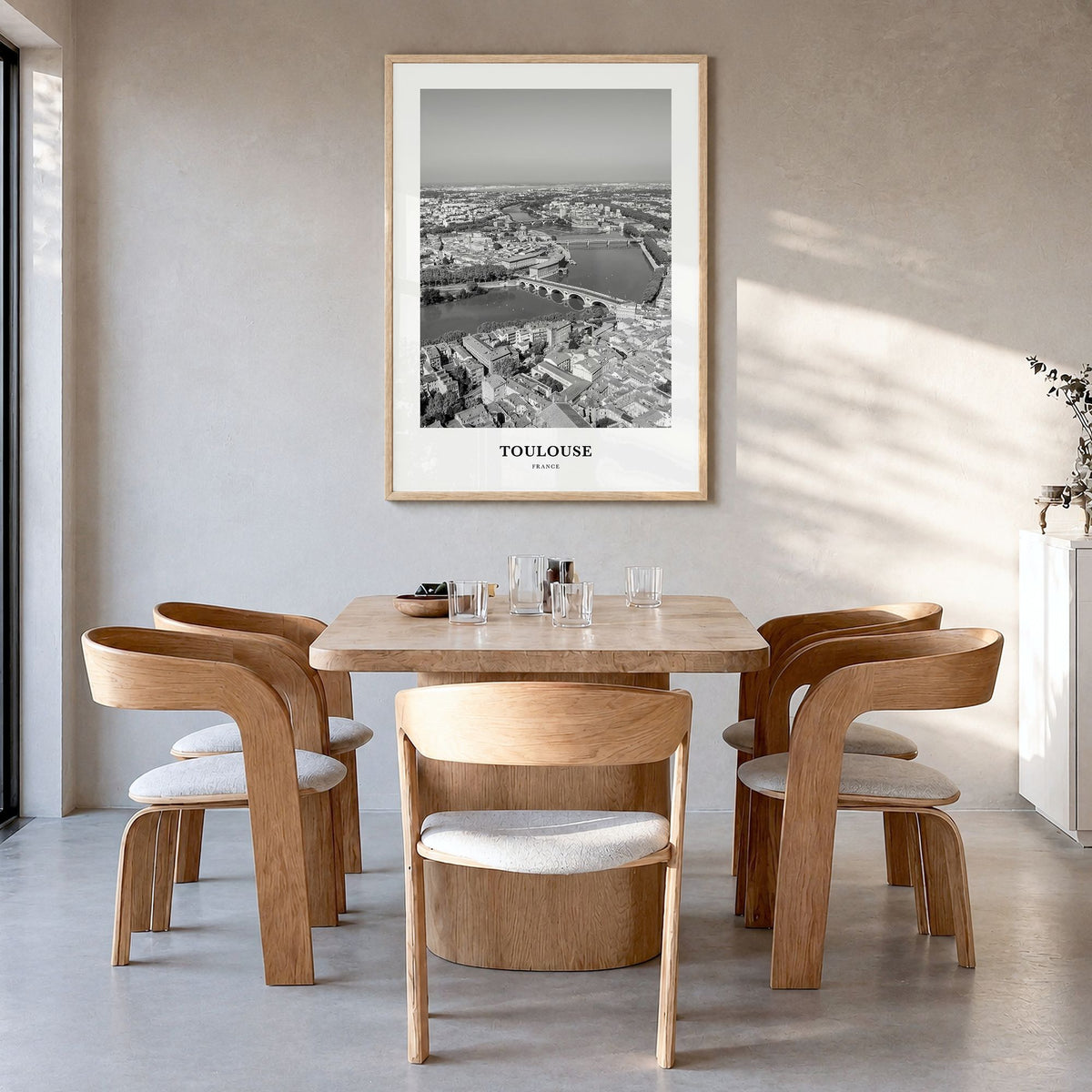 Toulouse Classic Poster in a natural wood frame, hanging in a dining room