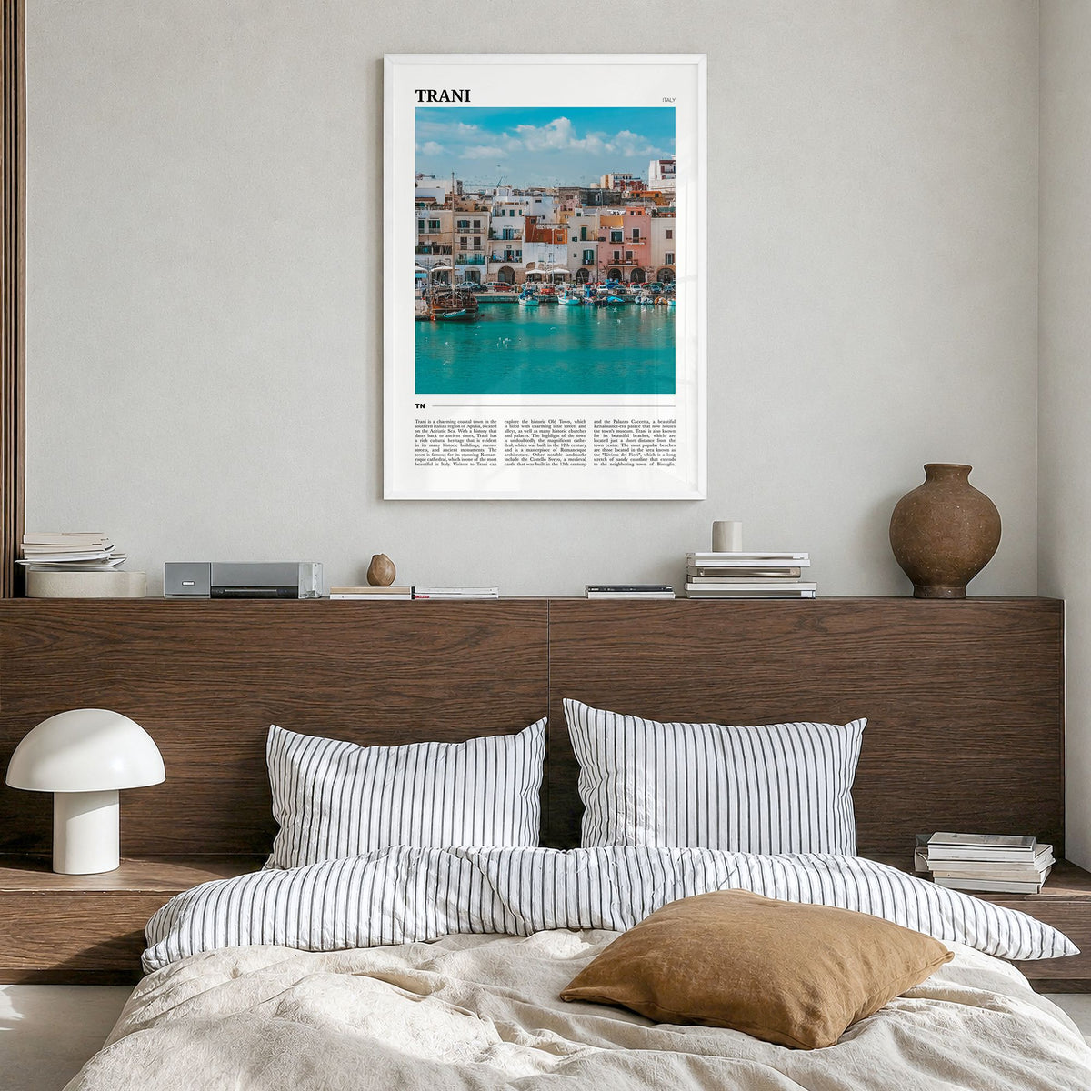 Trani Travel Poster in a white wood frame, hanging in a bedroom
