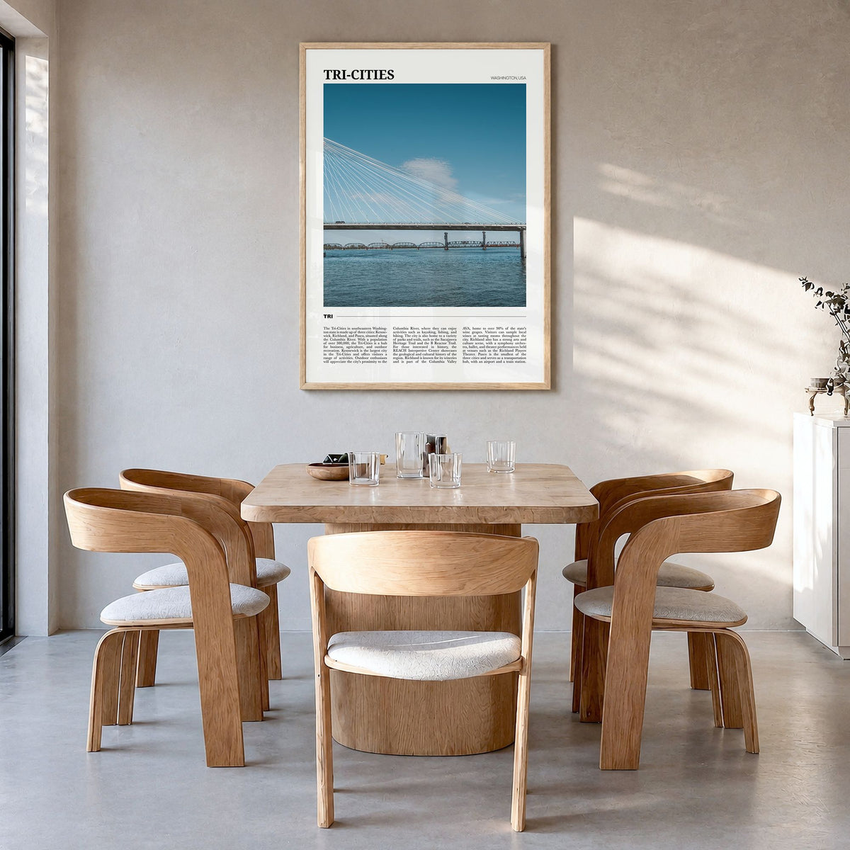 Tri-Cities Travel Poster in a natural wood frame, hanging in a dining room
