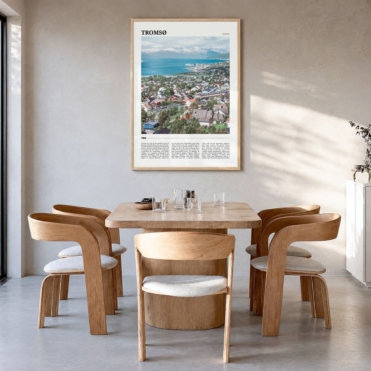 Tromsø Travel Poster in a natural wood frame, hanging in a dining room
