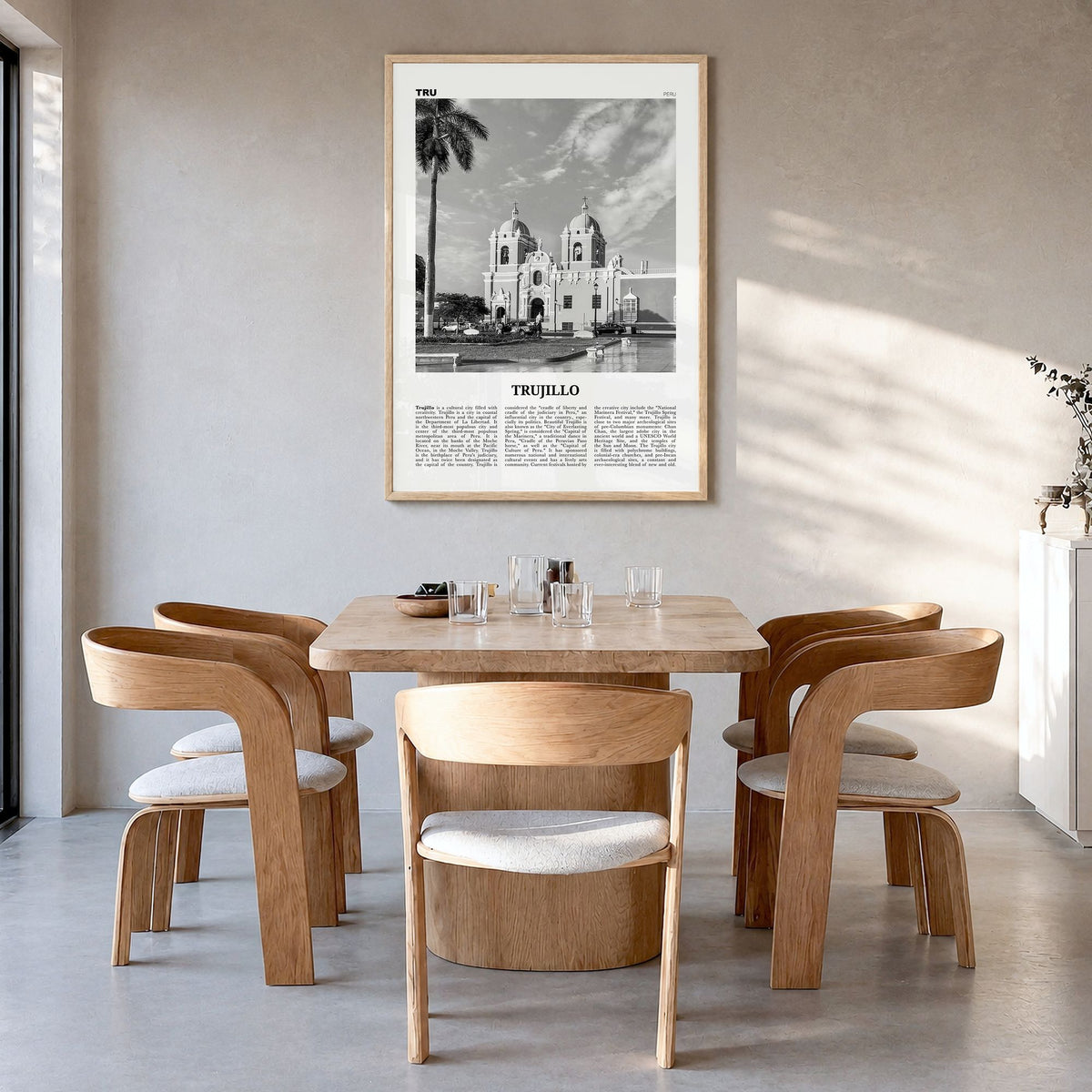 Trujillo Newspaper Poster in a natural wood frame, hanging in a dining room