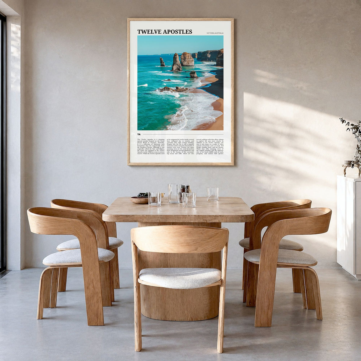 Twelve Apostles Travel Poster in a natural wood frame, hanging in a dining room