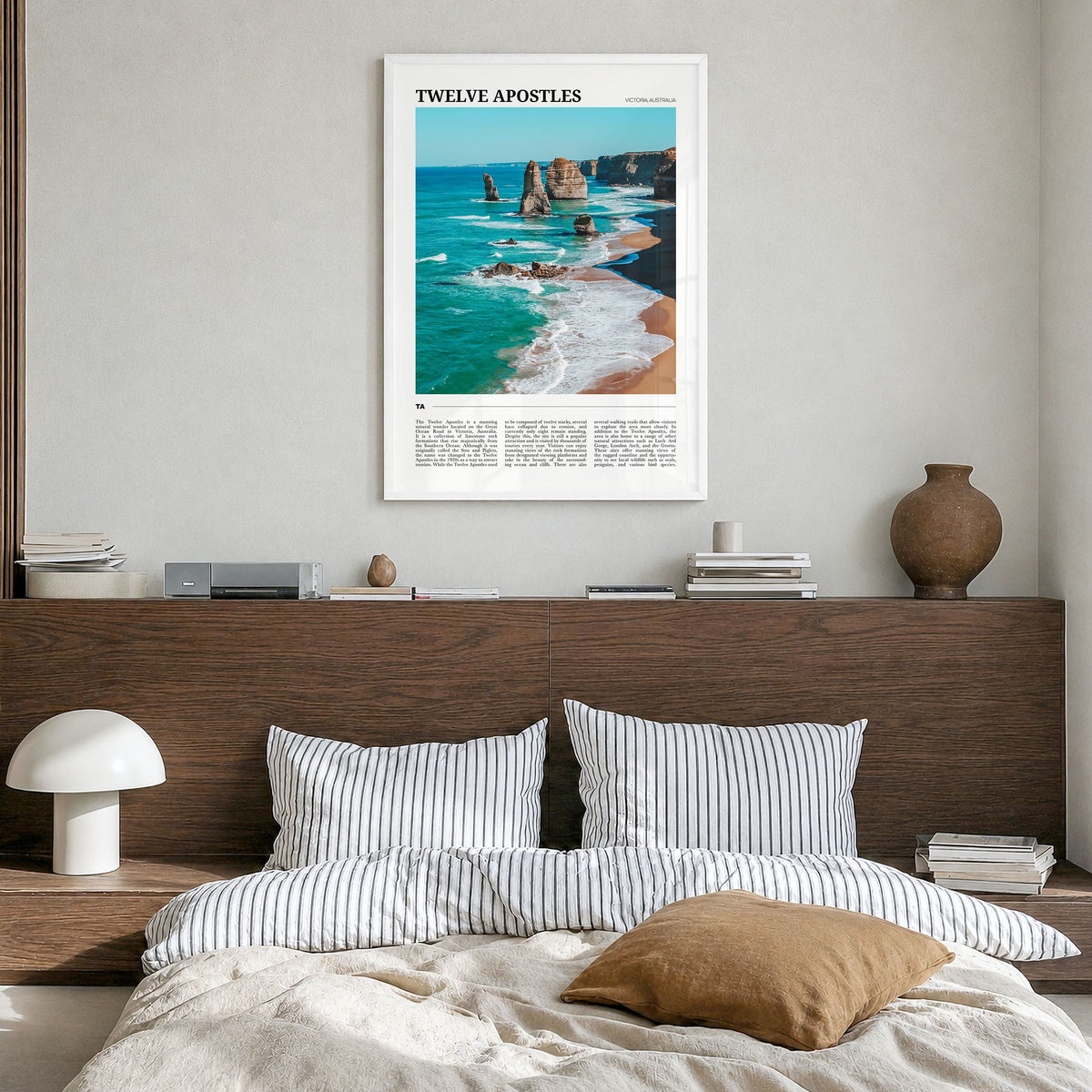 Twelve Apostles Travel Poster in a white wood frame, hanging in a bedroom