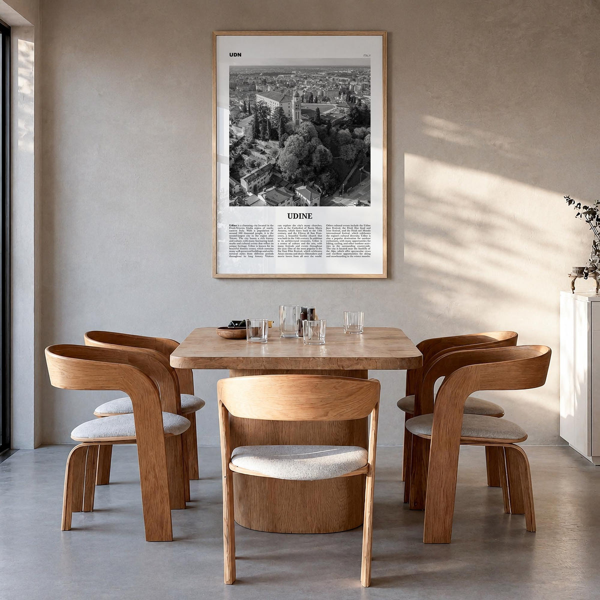 Udine black & white newspaper poster of Italy – vertical wall art in natural wood frame, hanging on wall